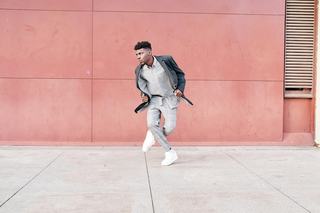 Africanamerican man dancing outdoors in casual clothes