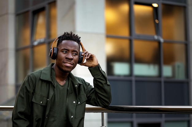 Africanamerican man in wireless headphones listening music