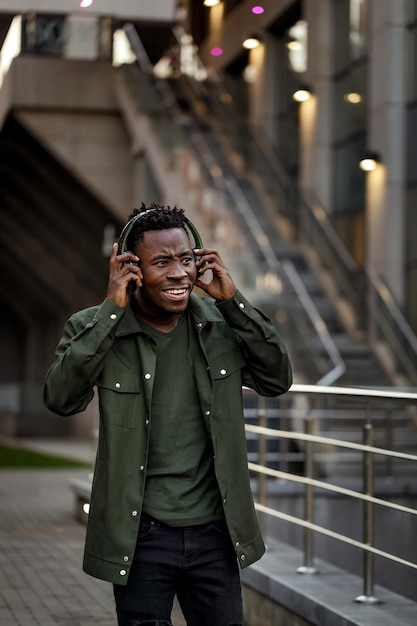 Africanamerican man in wireless headphones listening music