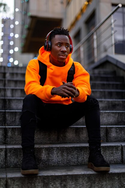 Africanamerican man in wireless headphones listening music