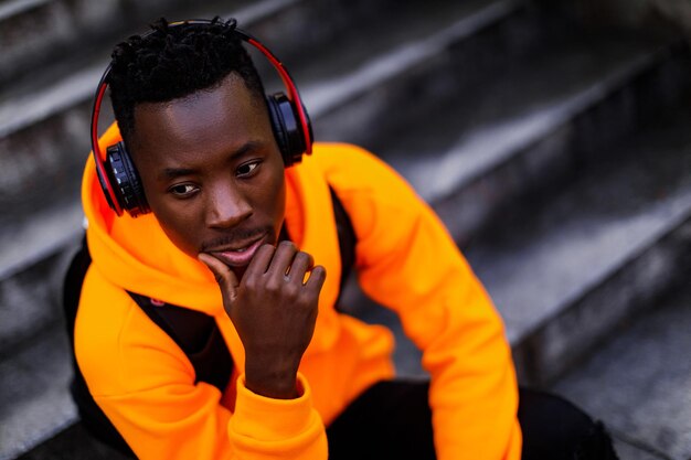 Africanamerican man in wireless headphones listening music