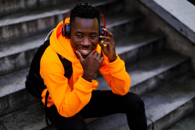 Africanamerican man in wireless headphones listening music