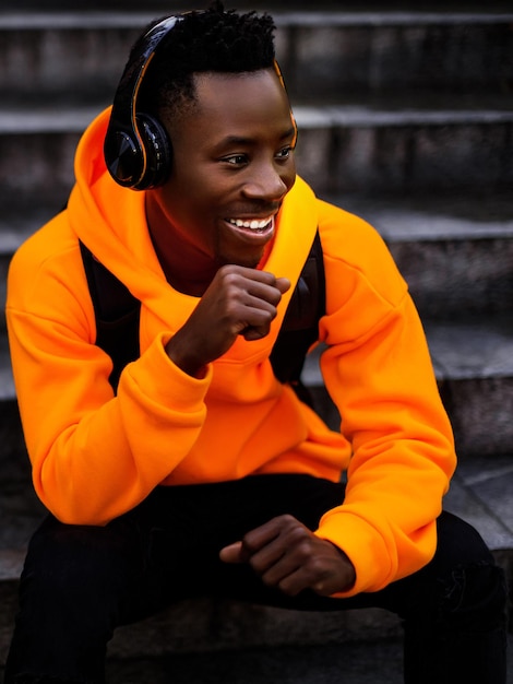 Africanamerican man in wireless headphones listening music