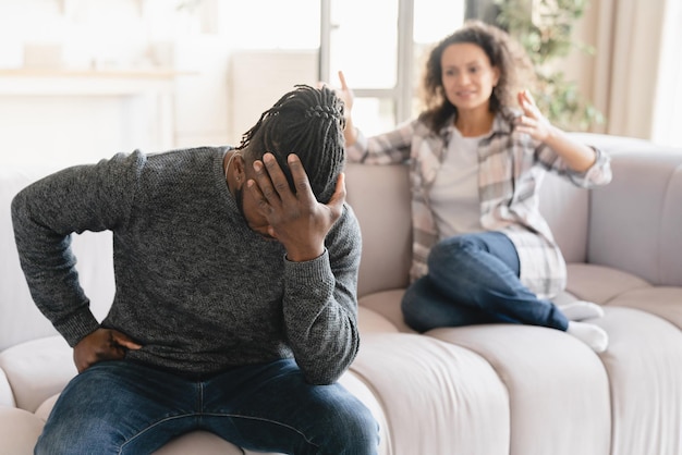 Africanamerican wife crying arguing scolding at her husband at home Misunderstanding between partners Cheating divorce breakup Abuse gaslighting Psychological therapy