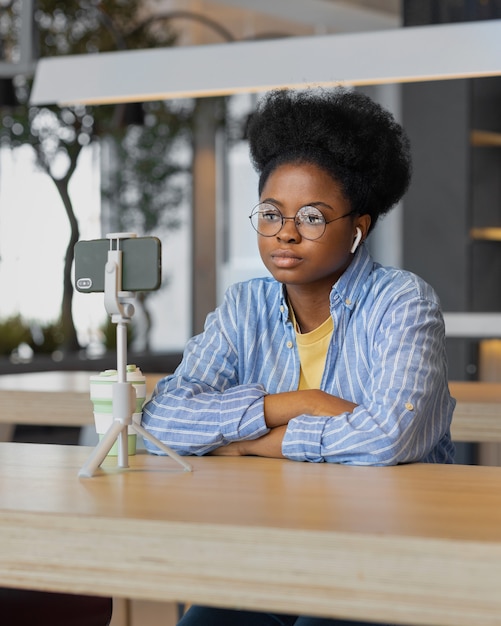 Africanamerican woman video chatting from her smartphone or watching live streaming