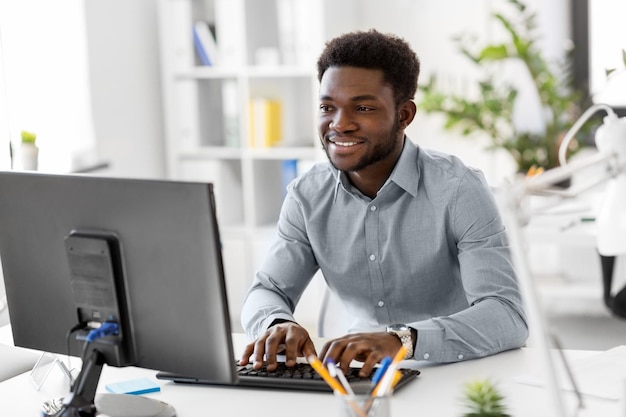 Afrikaanse zakenman met computer op kantoor