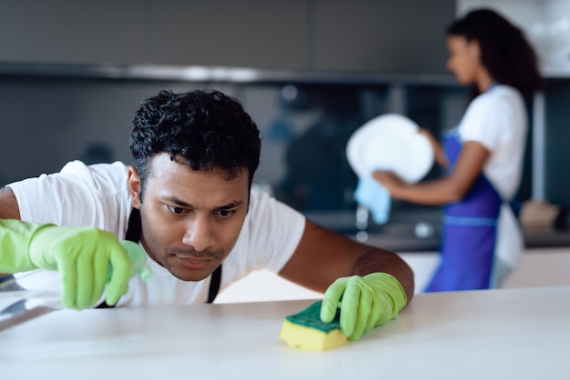 Afro American couple cleaning on kitchen