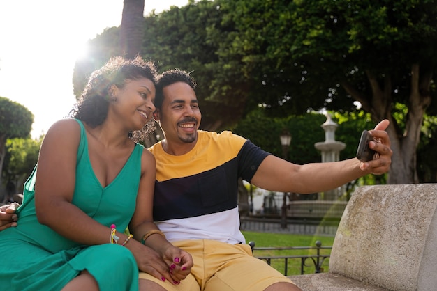 Afro-American couple taking a picture with the mobile