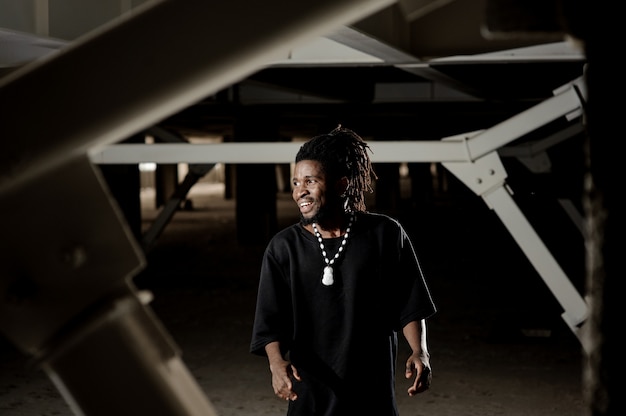 Afro-american man with dreadlocks dancing and smiling