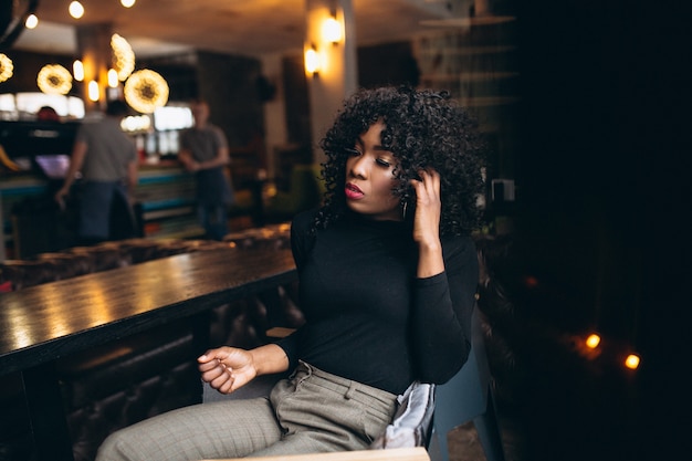 Afro american woman happy in a cafe