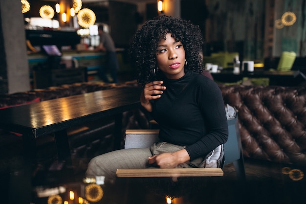 Afro american woman happy in a cafe