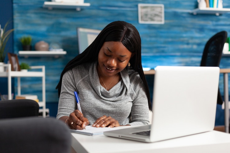 Photo afro american woman studying communication course writing high school lesson on notebook sitting at ...