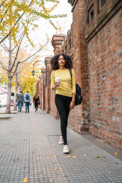 Afro-american woman walking on the street.
