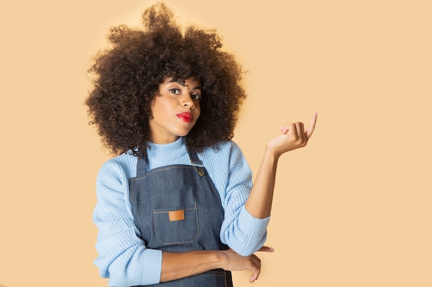 Afro American woman with apron, pensive