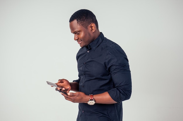 Afro american young holding phone in studio on white background