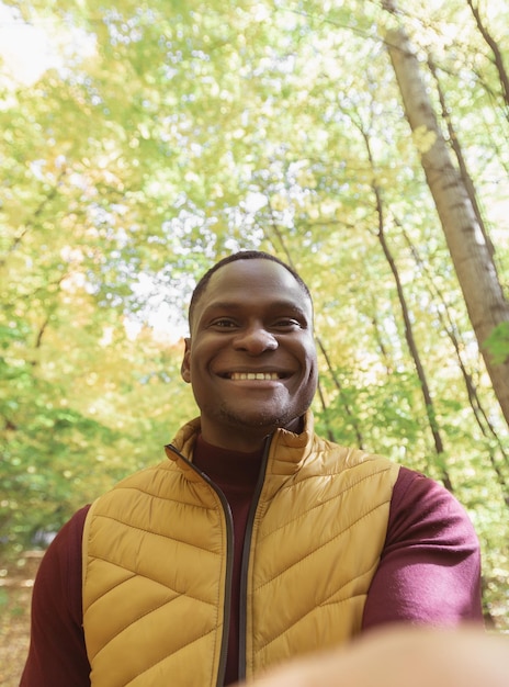 Afro-Amerikaanse man die een zelfportret maakt met een smartphone in de herfst herfst of videogesprek portret Gelukkig mensen seizoen en videogesprek concept