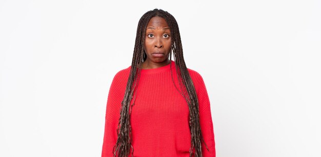 Afro black adult woman feeling sad and stressed, upset because of a bad surprise, with a negative, anxious look