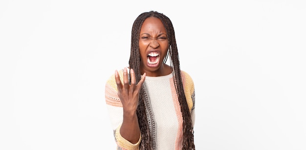 Afro black adult woman looking angry, annoyed and frustrated screaming wtf or whatÃÂ¢ÃÂÃÂs wrong with you