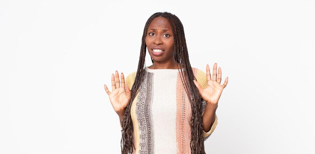 Afro black adult woman looking nervous, anxious and concerned, saying not my fault or I didnât do it