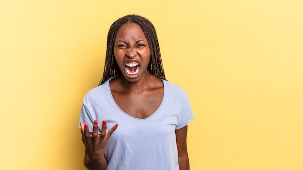 Afro black pretty woman looking angry, annoyed and frustrated screaming wtf or whatÃ¢ÂÂs wrong with you