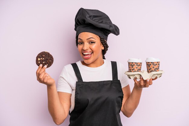 Afro black woman chef with braids and making a cookie