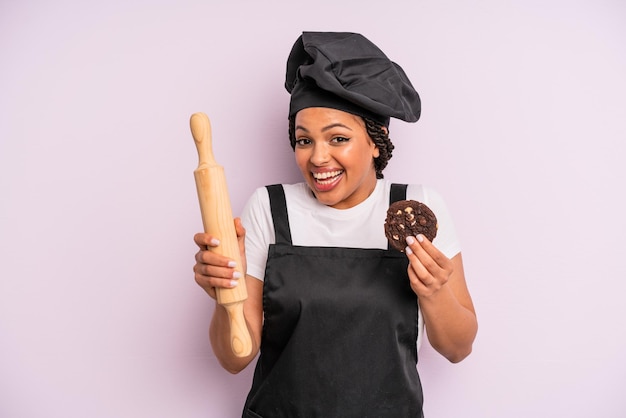 Afro black woman chef with braids and making a cookie