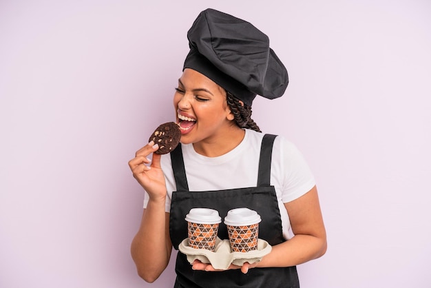 Afro black woman chef with braids and making a cookie