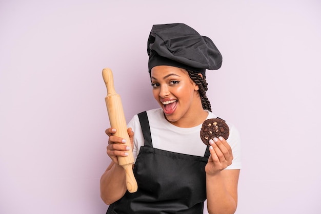 Afro black woman chef with braids and making a cookie