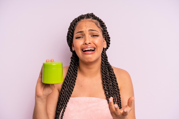 afro black woman looking desperate, frustrated and stressed. hair treatment concept