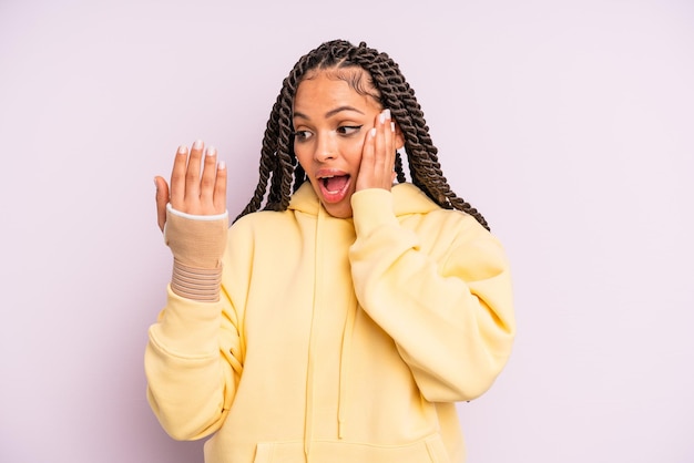 Afro black woman with braids and broken hand