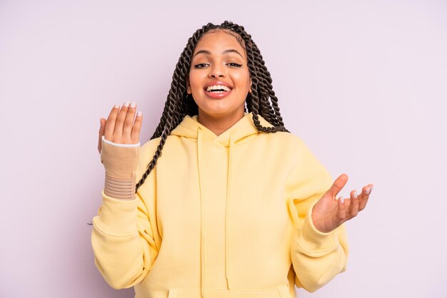 Afro black woman with braids and broken hand