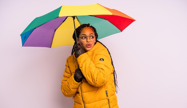 Afro black woman with braids with an umbrella winter concept