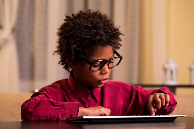 Afro boy using wireless keyboard.