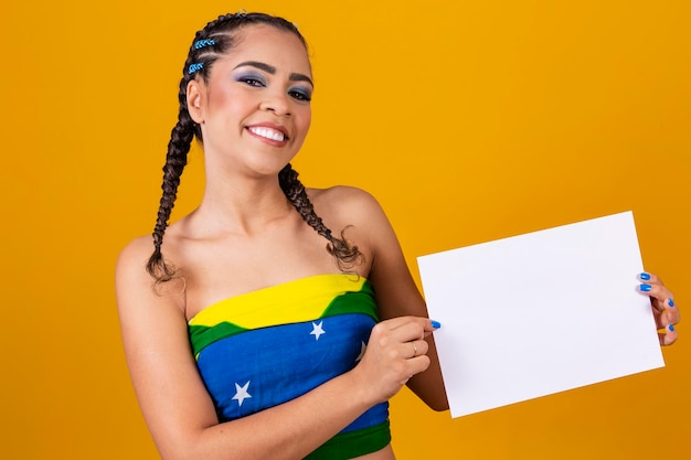 Afro brazilian woman cheerleader holding a blank sign with free space for text
