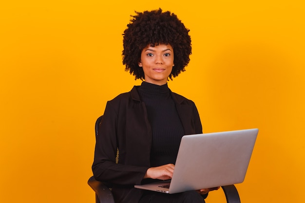 Afro business woman working online with laptop computer.