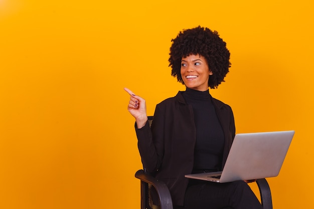 Afro business woman working online with laptop computer.