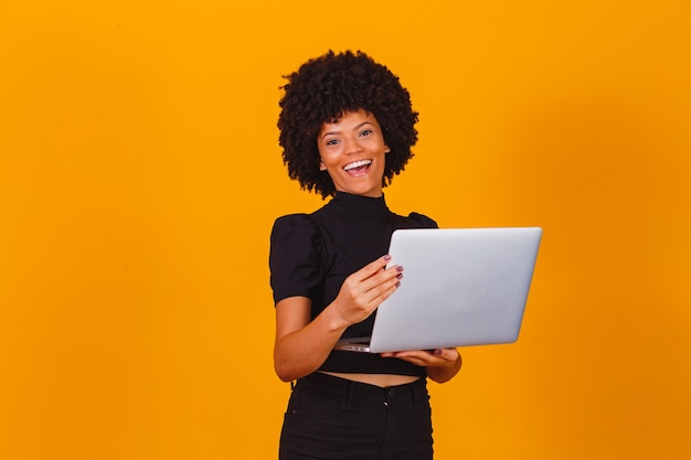 Afro business woman working online with laptop computer.