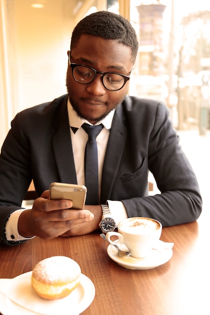 Afro businessman having a coffee