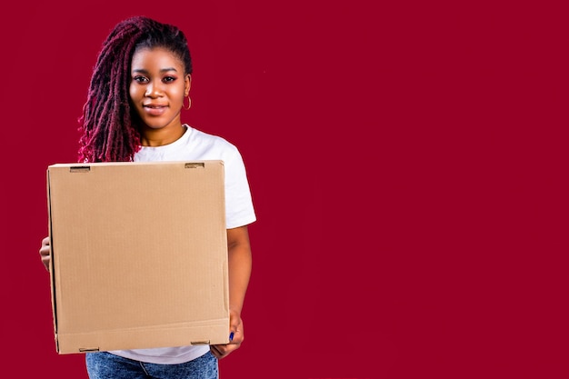 Afro cheerful woman holding emty copyspace cardboard