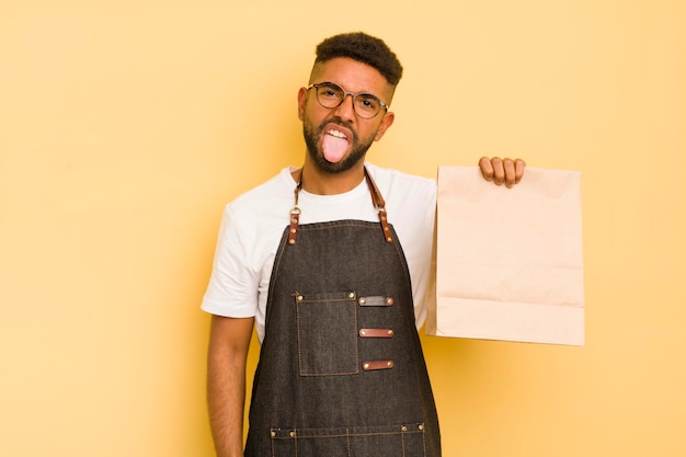 Afro cool man feeling disgusted and irritated and tongue out deliveryman and fast food concept