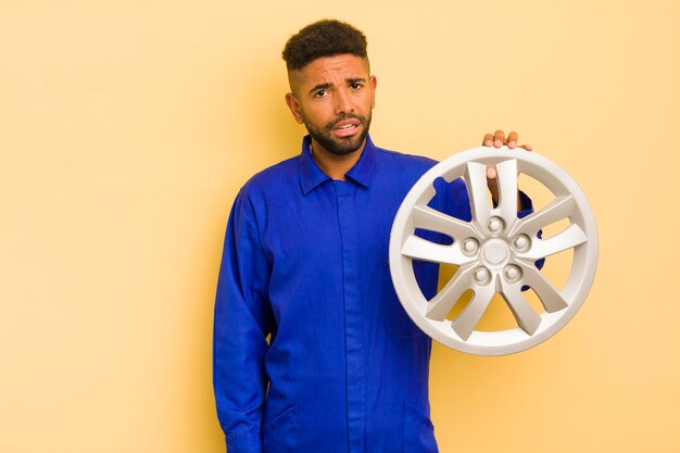 Afro cool man feeling puzzled and confused bike repairman concept