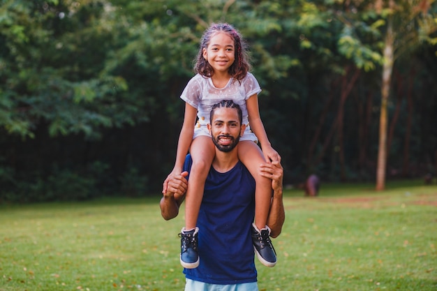 Afro father and daughter in the park