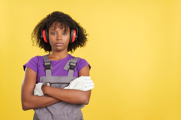 Afro female carpenter crossing arms with serious expression