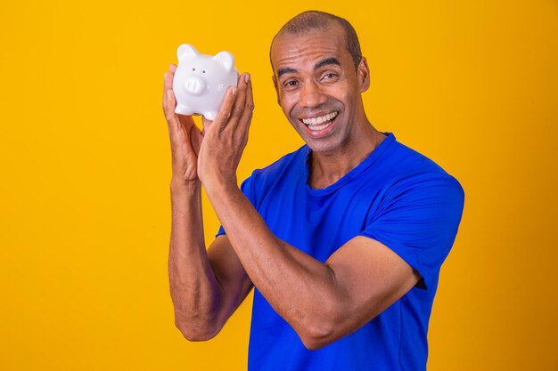 Afro man holding a piggybank