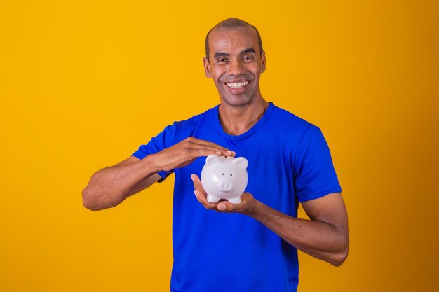 Afro man holding a piggybank