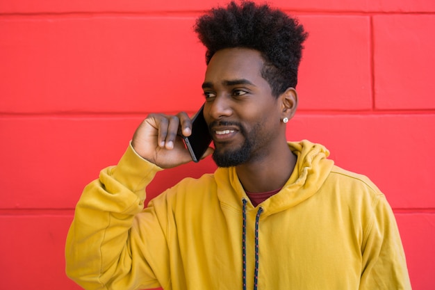 Afro man talking on the phone.