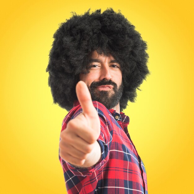 Afro man with thumb up  on colorful background