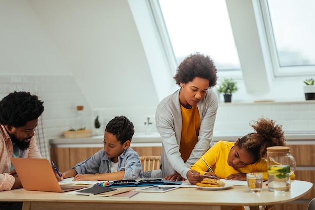 Afro parents helping their children with his homework