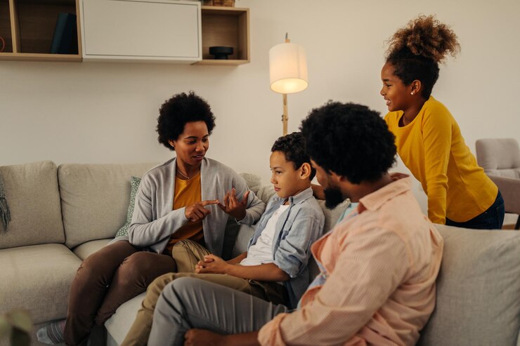 Photo afro parents and their children bonding at home sitting on sofa in the living room and socializing