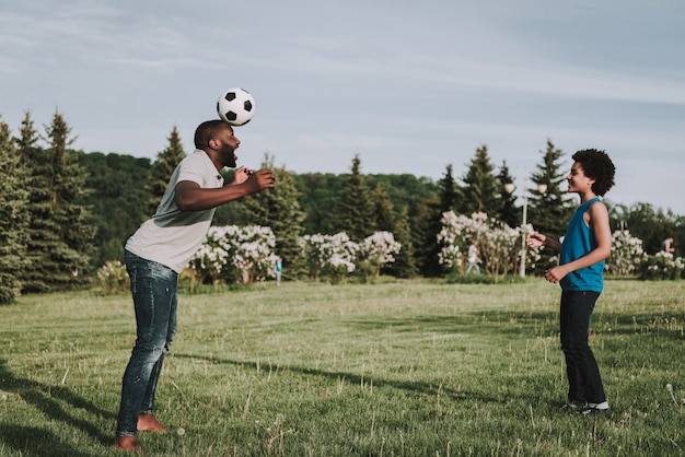 Afro Son and Afro Father Play Together in Ball